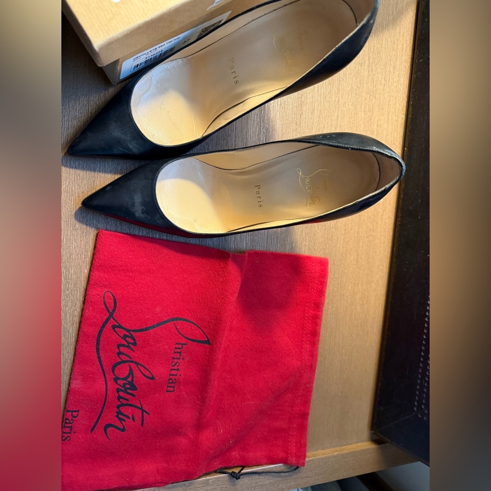 Black designer shoes. Barely worn. The red bottoms have a protective layer on.